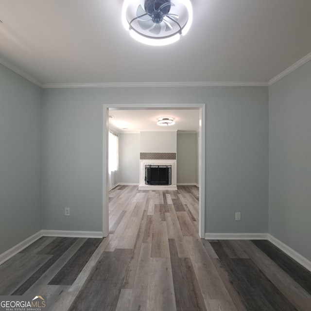 3433 Sandra Fay Dr, Macon, GA 31206 - unfurnished living room with wood finished floors, crown molding, baseboards, and a fireplace
