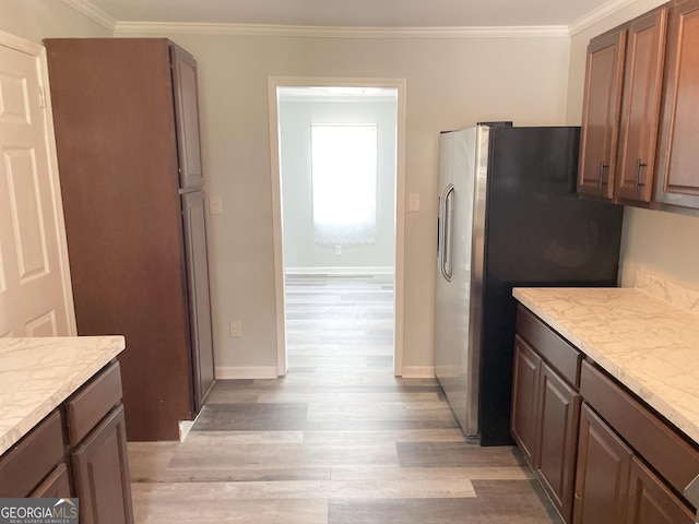3433 Sandra Fay Dr, Macon, GA 31206 - kitchen featuring light wood-style flooring, stainless steel fridge, crown molding, and baseboards