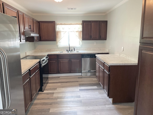 3433 Sandra Fay Dr, Macon, GA 31206 - kitchen with appliances with stainless steel finishes, a sink, light wood-style floors, ornamental molding, and light countertops