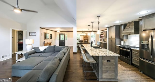180 Mountain Path, Rockmart, GA 30153 - kitchen with appliances with stainless steel finishes, open floor plan, a sink, wall chimney range hood, and a kitchen breakfast bar