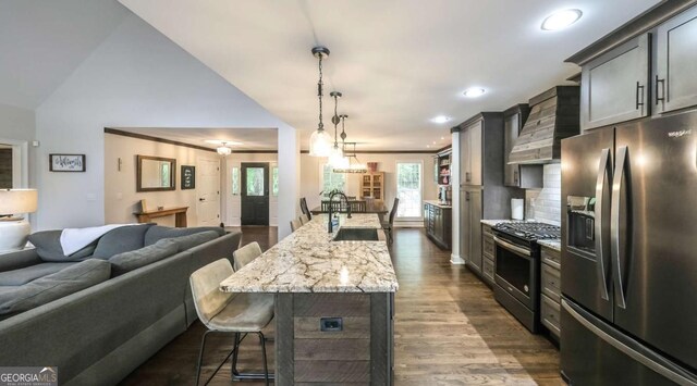 180 Mountain Path, Rockmart, GA 30153 - kitchen with stainless steel appliances, a sink, wall chimney exhaust hood, a kitchen breakfast bar, and open floor plan