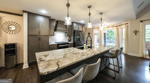 180 Mountain Path, Rockmart, GA 30153 - kitchen with gas stove, baseboards, premium range hood, stainless steel fridge, and a breakfast bar
