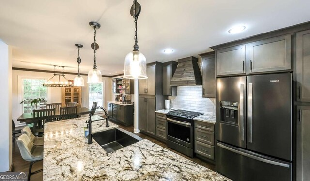 180 Mountain Path, Rockmart, GA 30153 - kitchen featuring appliances with stainless steel finishes, wall chimney range hood, a sink, light stone countertops, and decorative backsplash