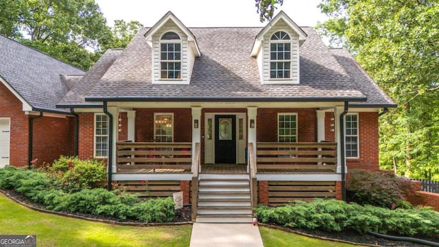 180 Mountain Path, Rockmart, GA 30153 - new england style home with a porch, roof with shingles, brick siding, and an attached garage