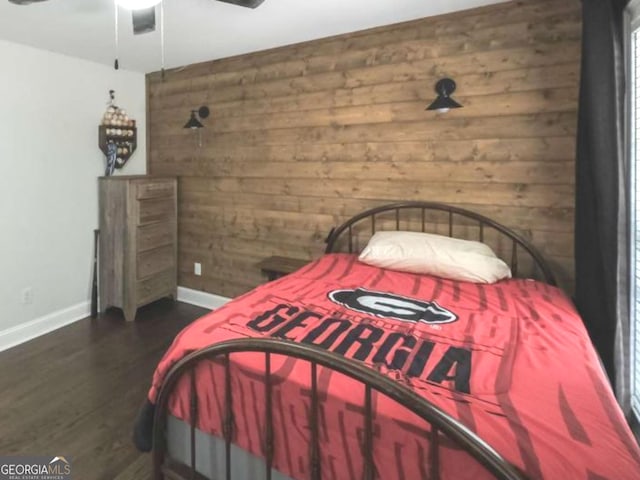 180 Mountain Path, Rockmart, GA 30153 - bedroom featuring wooden walls, baseboards, dark wood-style floors, and a ceiling fan