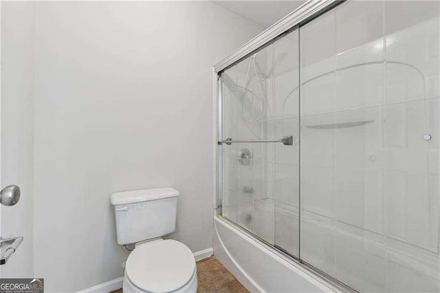 3134 Flery Way, Lawrenceville, GA 30046 - bathroom with baseboards, toilet, and bath / shower combo with glass door