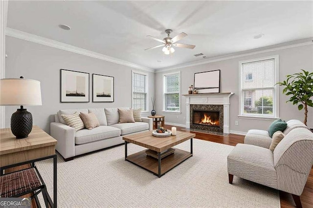 3134 Flery Way, Lawrenceville, GA 30046 - living room with ceiling fan, wood finished floors, healthy amount of natural light, a high end fireplace, and ornamental molding