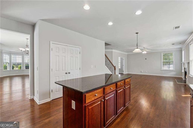 3134 Flery Way, Lawrenceville, GA 30046 - kitchen featuring open floor plan, dark wood-type flooring, ceiling fan, a chandelier, and crown molding