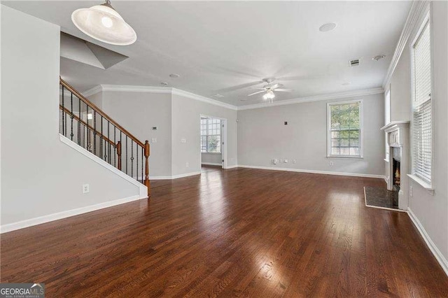 3134 Flery Way, Lawrenceville, GA 30046 - unfurnished living room featuring a ceiling fan, a lit fireplace, wood finished floors, stairway, and crown molding