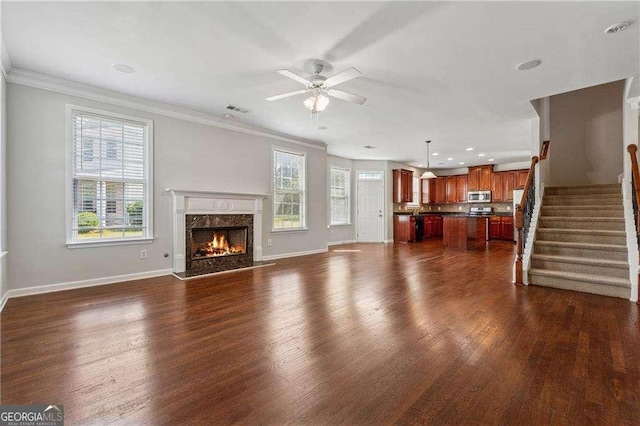 3134 Flery Way, Lawrenceville, GA 30046 - unfurnished living room with ceiling fan, baseboards, dark wood-type flooring, crown molding, and a premium fireplace