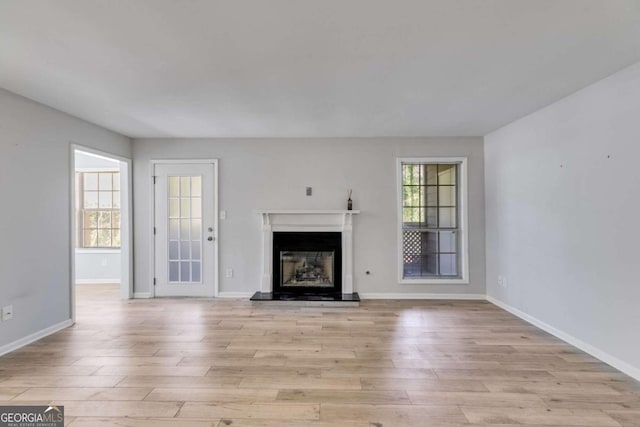 2135 N Forest Trl, Atlanta, GA 30338 - unfurnished living room with light wood finished floors and a glass covered fireplace