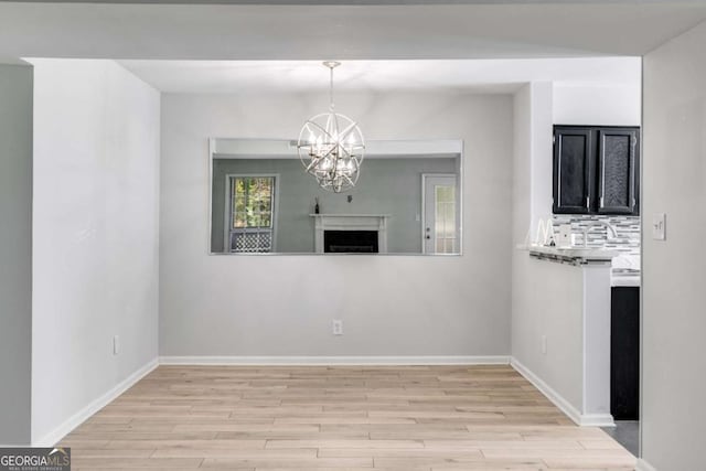 2135 N Forest Trl, Atlanta, GA 30338 - unfurnished living room featuring a chandelier and light wood finished floors