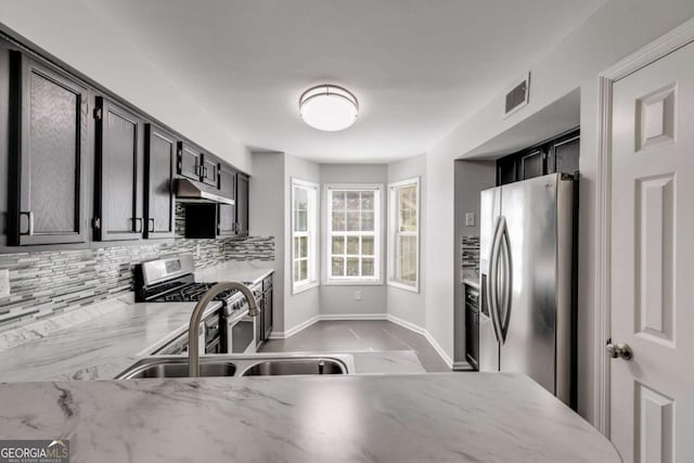 2135 N Forest Trl, Atlanta, GA 30338 - kitchen featuring appliances with stainless steel finishes, under cabinet range hood, tasteful backsplash, and light stone countertops