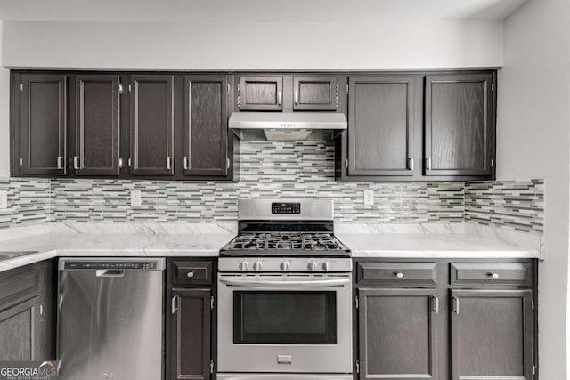 2135 N Forest Trl, Atlanta, GA 30338 - kitchen with appliances with stainless steel finishes, under cabinet range hood, decorative backsplash, and light stone countertops