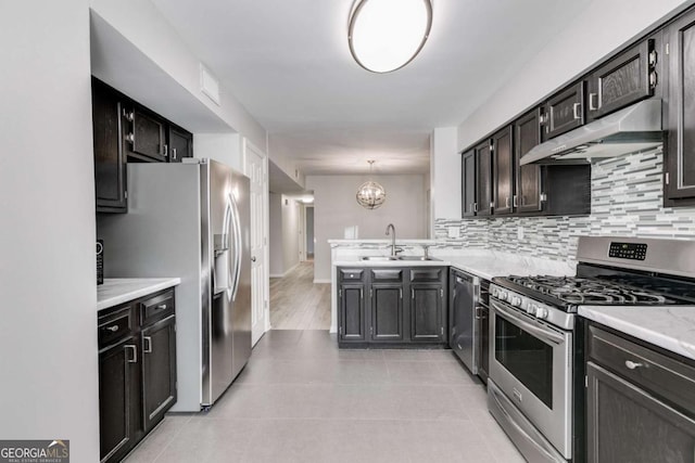 2135 N Forest Trl, Atlanta, GA 30338 - kitchen featuring stainless steel appliances, under cabinet range hood, decorative backsplash, and light countertops