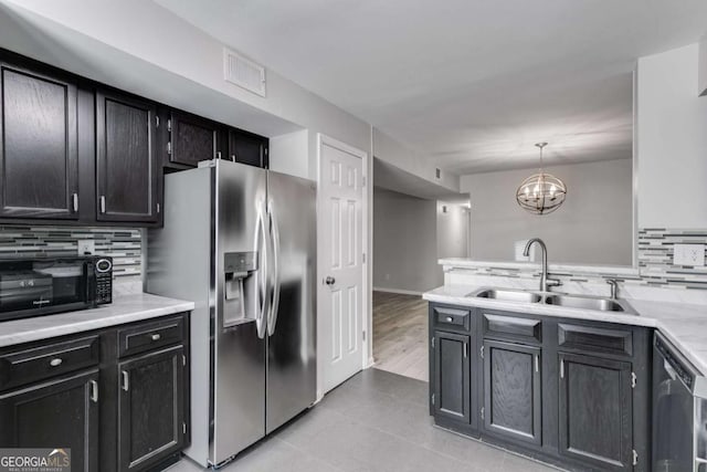 2135 N Forest Trl, Atlanta, GA 30338 - kitchen with stainless steel appliances, decorative backsplash, light countertops, a chandelier, and pendant lighting