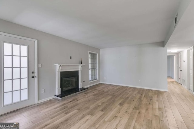 2135 N Forest Trl, Atlanta, GA 30338 - unfurnished living room with a glass covered fireplace and light wood-style floors