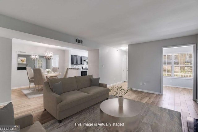 2135 N Forest Trl, Atlanta, GA 30338 - living room featuring light wood finished floors and a chandelier