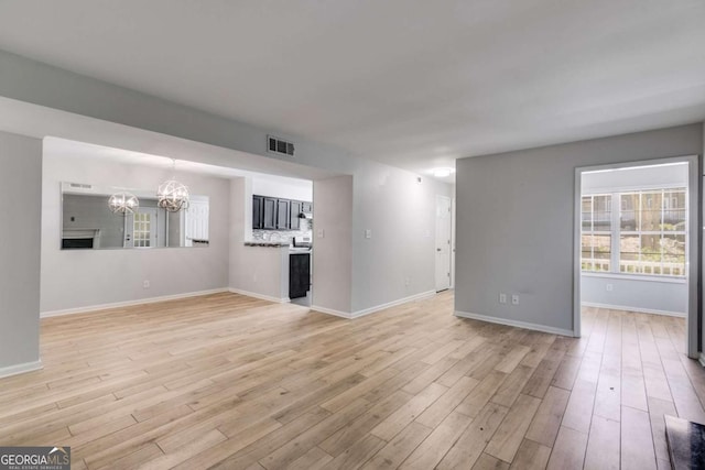 2135 N Forest Trl, Atlanta, GA 30338 - unfurnished living room featuring a chandelier and light wood-style floors
