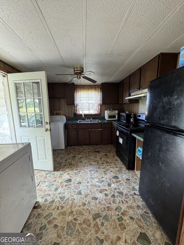 1963 Antioch Church Rd, Eastman, GA 31023 - kitchen featuring black appliances, washer / dryer, under cabinet range hood, and ceiling fan