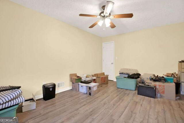 4845 Willow St, Acworth, GA 30101 - bedroom featuring wood finished floors, a textured ceiling, and a ceiling fan