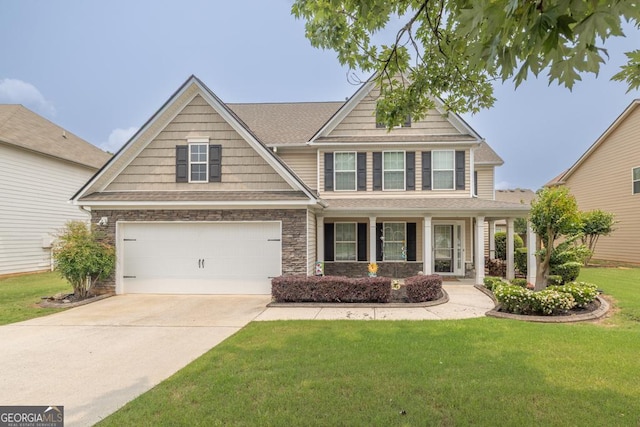 3338 Gardenside Walk, Loganville, GA 30052 - craftsman inspired home featuring driveway, a front yard, a garage, a porch, and stone siding