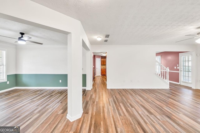 3338 Gardenside Walk, Loganville, GA 30052 - spare room with a ceiling fan, wood finished floors, and a textured ceiling