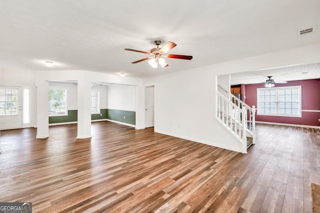3338 Gardenside Walk, Loganville, GA 30052 - unfurnished living room with a ceiling fan, wood finished floors, and stairway