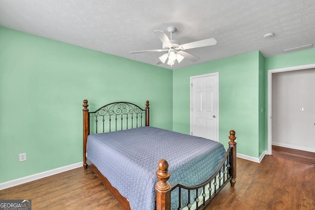 3338 Gardenside Walk, Loganville, GA 30052 - bedroom with wood finished floors, ceiling fan, and a textured ceiling