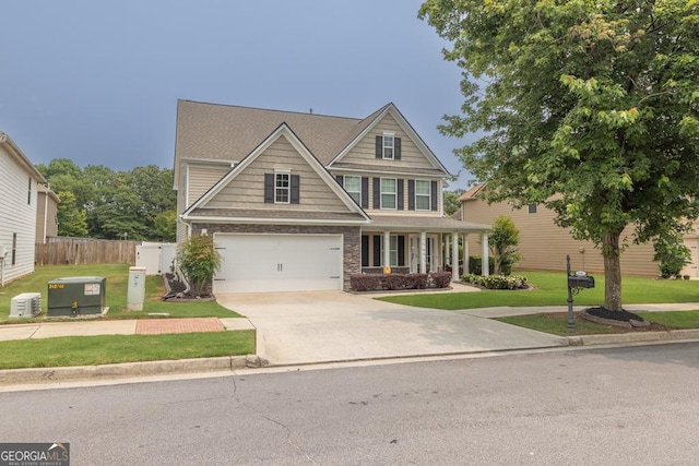 3338 Gardenside Walk, Loganville, GA 30052 - craftsman inspired home featuring concrete driveway, a garage, and covered porch