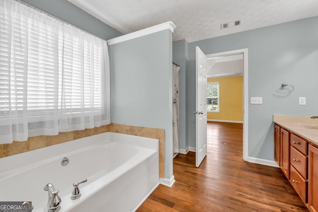 3338 Gardenside Walk, Loganville, GA 30052 - full bath featuring a bath, wood finished floors, and vanity