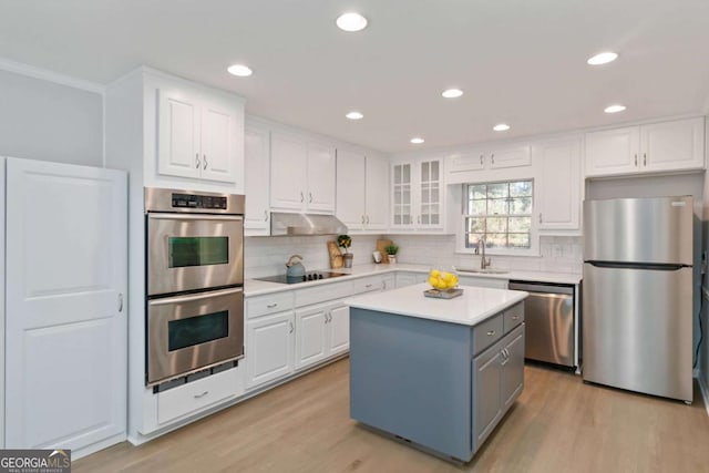 935 Old Loganville Rd, Loganville, GA 30052 - kitchen featuring stainless steel appliances, white cabinets, light wood-style flooring, and recessed lighting