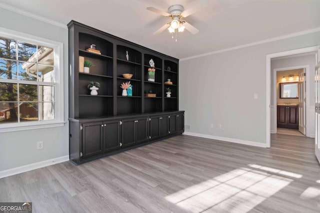 935 Old Loganville Rd, Loganville, GA 30052 - empty room featuring crown molding, light wood-style flooring, and a ceiling fan