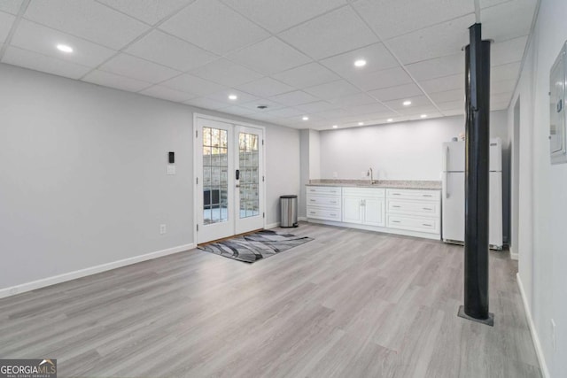 935 Old Loganville Rd, Loganville, GA 30052 - below grade area featuring freestanding refrigerator, light wood-type flooring, recessed lighting, bar with sink, and a drop ceiling