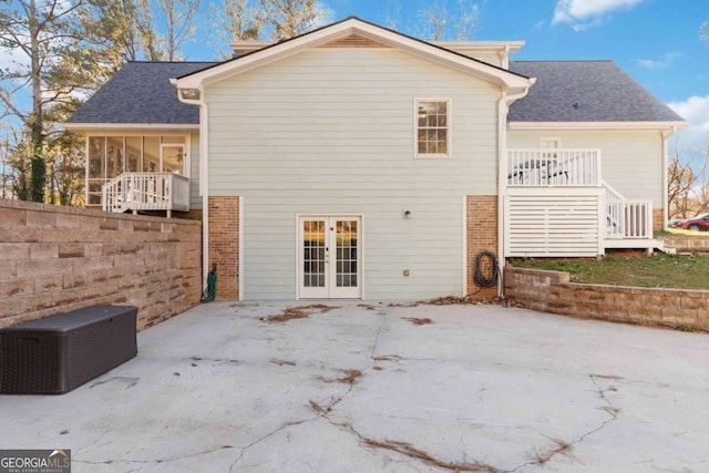 935 Old Loganville Rd, Loganville, GA 30052 - back of property featuring french doors, brick siding, roof with shingles, stairs, and a patio area