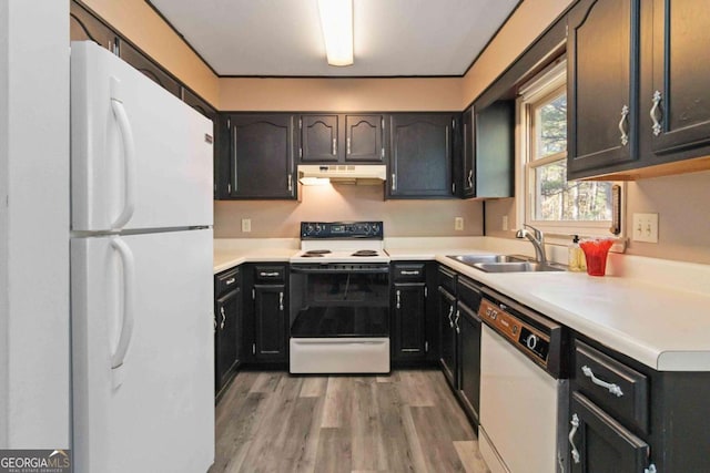 935 Old Loganville Rd, Loganville, GA 30052 - kitchen with white appliances, under cabinet range hood, light wood-type flooring, and light countertops