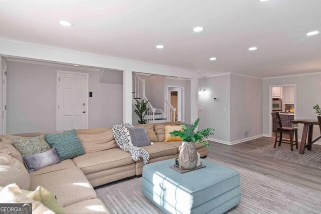 935 Old Loganville Rd, Loganville, GA 30052 - living area with crown molding, wood finished floors, stairway, and recessed lighting