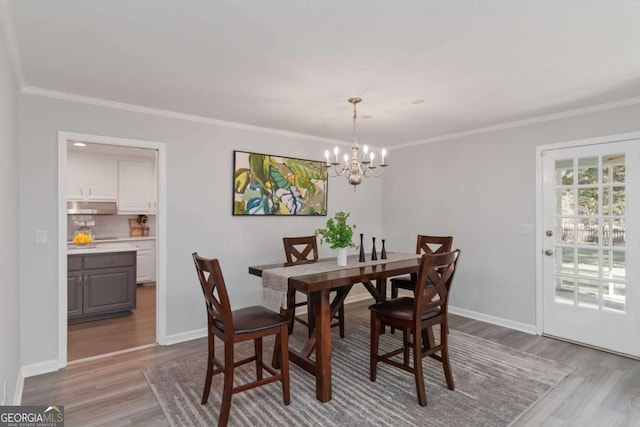 935 Old Loganville Rd, Loganville, GA 30052 - dining room with wood finished floors, a chandelier, and ornamental molding