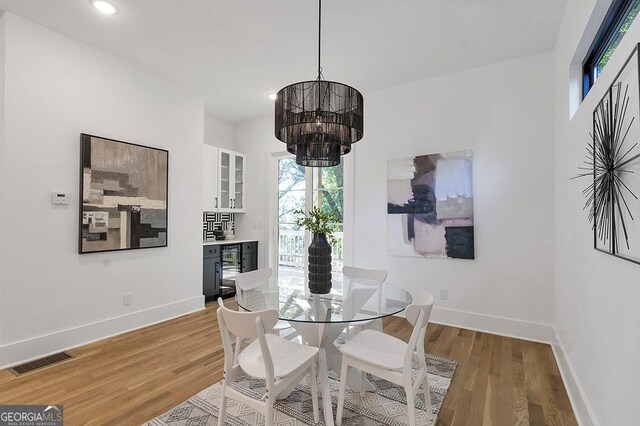 1464 Ezra Church Dr NW, Atlanta, GA 30314 - dining area with light wood finished floors, baseboards, a chandelier, and recessed lighting