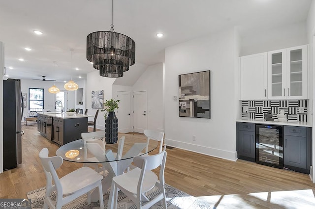 1464 Ezra Church Dr NW, Atlanta, GA 30314 - dining room with wine cooler, light wood-style floors, baseboards, recessed lighting, and a ceiling fan