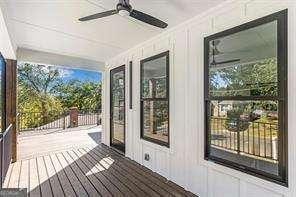 1464 Ezra Church Dr NW, Atlanta, GA 30314 - doorway to outside with healthy amount of natural light, ceiling fan, crown molding, and a decorative wall