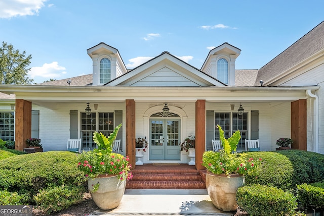 206 Savanna Estates Ct, Canton, GA 30115 - view of exterior entry featuring a porch, brick siding, and french doors