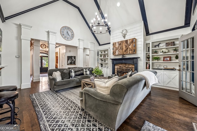 206 Savanna Estates Ct, Canton, GA 30115 - living area featuring decorative columns, a warm lit fireplace, high vaulted ceiling, dark wood finished floors, and a chandelier