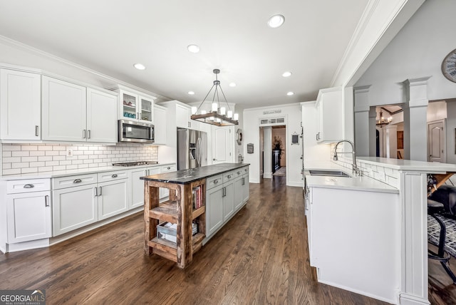 206 Savanna Estates Ct, Canton, GA 30115 - kitchen featuring stainless steel appliances, a chandelier, tasteful backsplash, crown molding, and white cabinetry