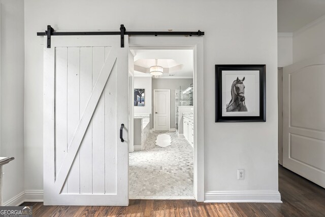 206 Savanna Estates Ct, Canton, GA 30115 - hallway featuring a barn door, wood finished floors, and ornamental molding