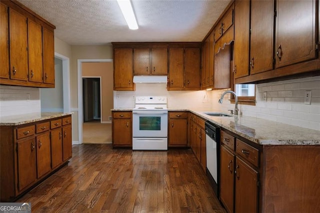 110 Fox Meadow Dr, Covington, GA 30016 - kitchen with electric range, a sink, under cabinet range hood, dark wood finished floors, and backsplash