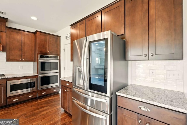 847 Rolling Hl, Kennesaw, GA 30152 - kitchen with stainless steel appliances, decorative backsplash, light stone counters, dark wood-style floors, and recessed lighting
