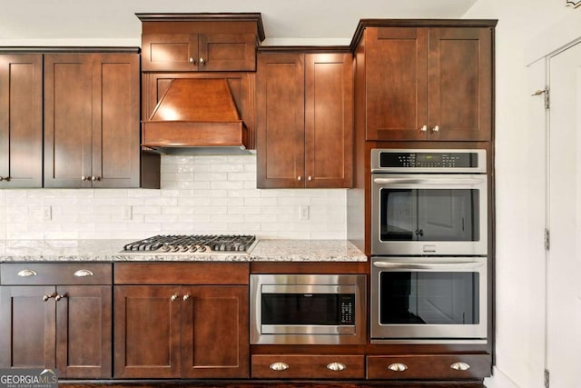 847 Rolling Hl, Kennesaw, GA 30152 - kitchen featuring custom exhaust hood, appliances with stainless steel finishes, tasteful backsplash, and light stone counters