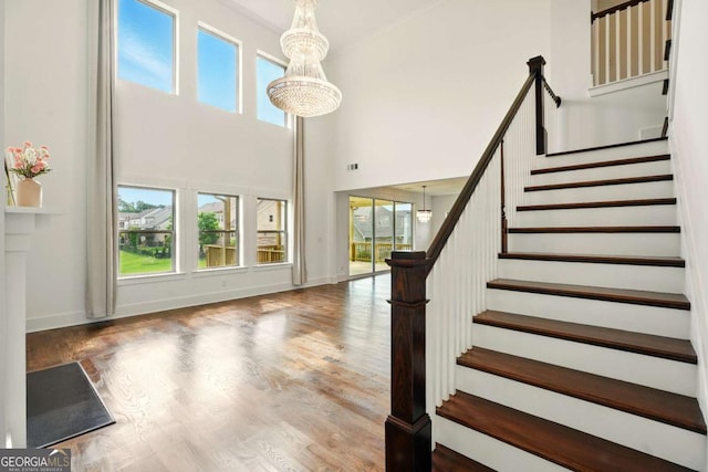 847 Rolling Hl, Kennesaw, GA 30152 - staircase with a towering ceiling, wood finished floors, baseboards, and a chandelier
