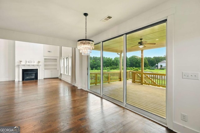 847 Rolling Hl, Kennesaw, GA 30152 - unfurnished living room featuring ceiling fan, wood finished floors, a chandelier, a fireplace, and built in features